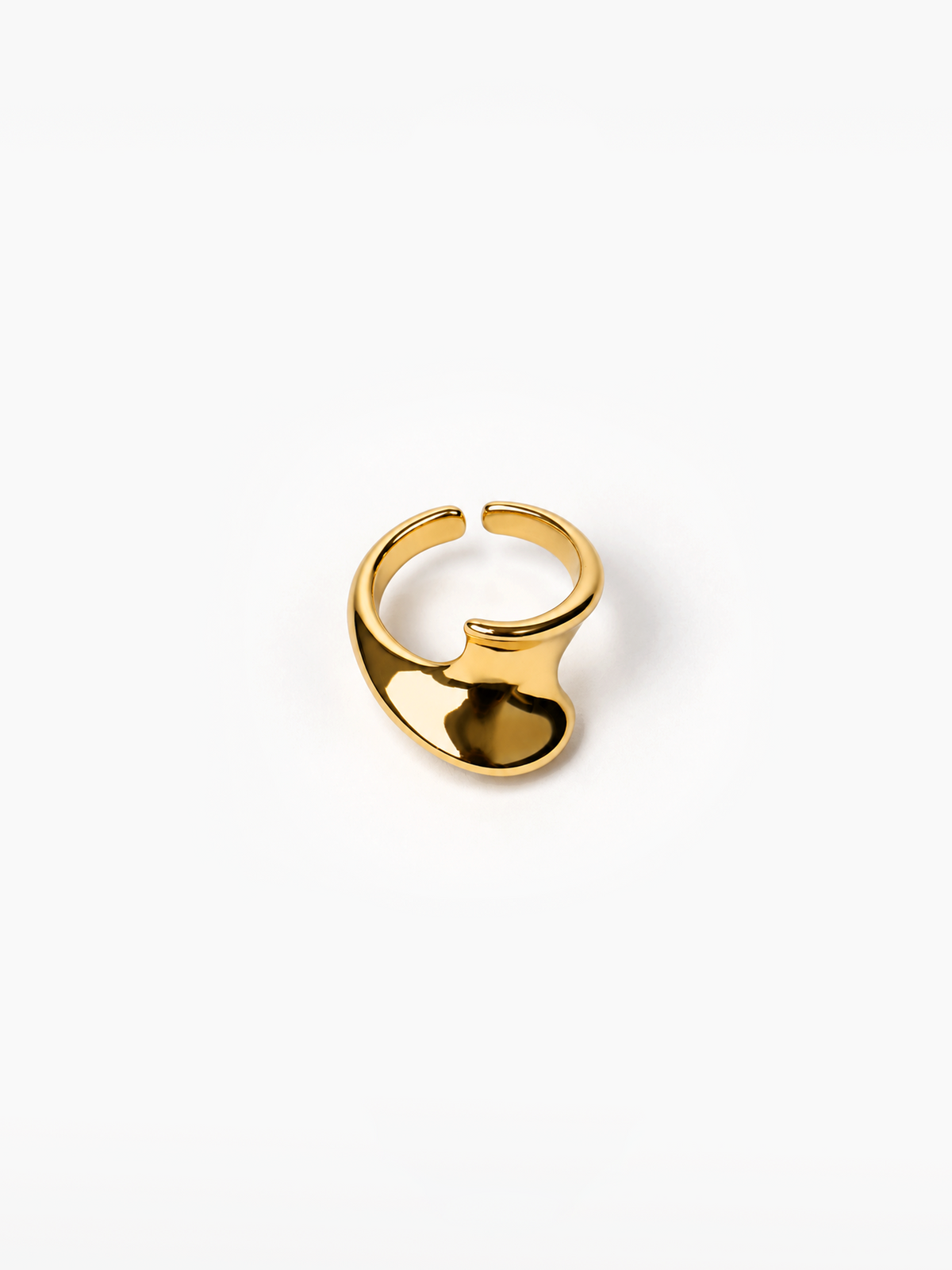 A polished gold-plated metal ring with a unique, organic wavy shape, photographed on a clean white background.